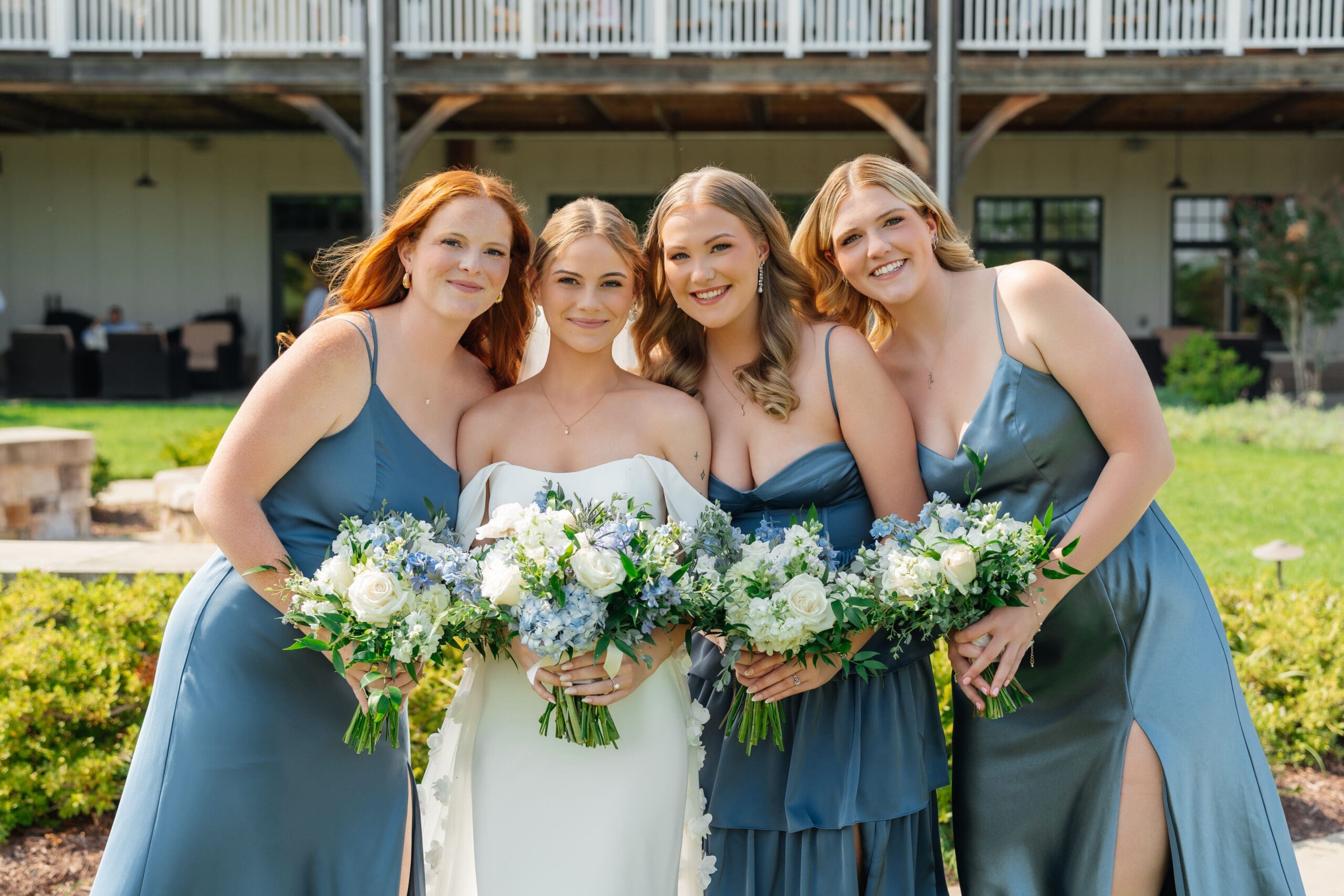 Bride and bridesmaids posing together outdoors