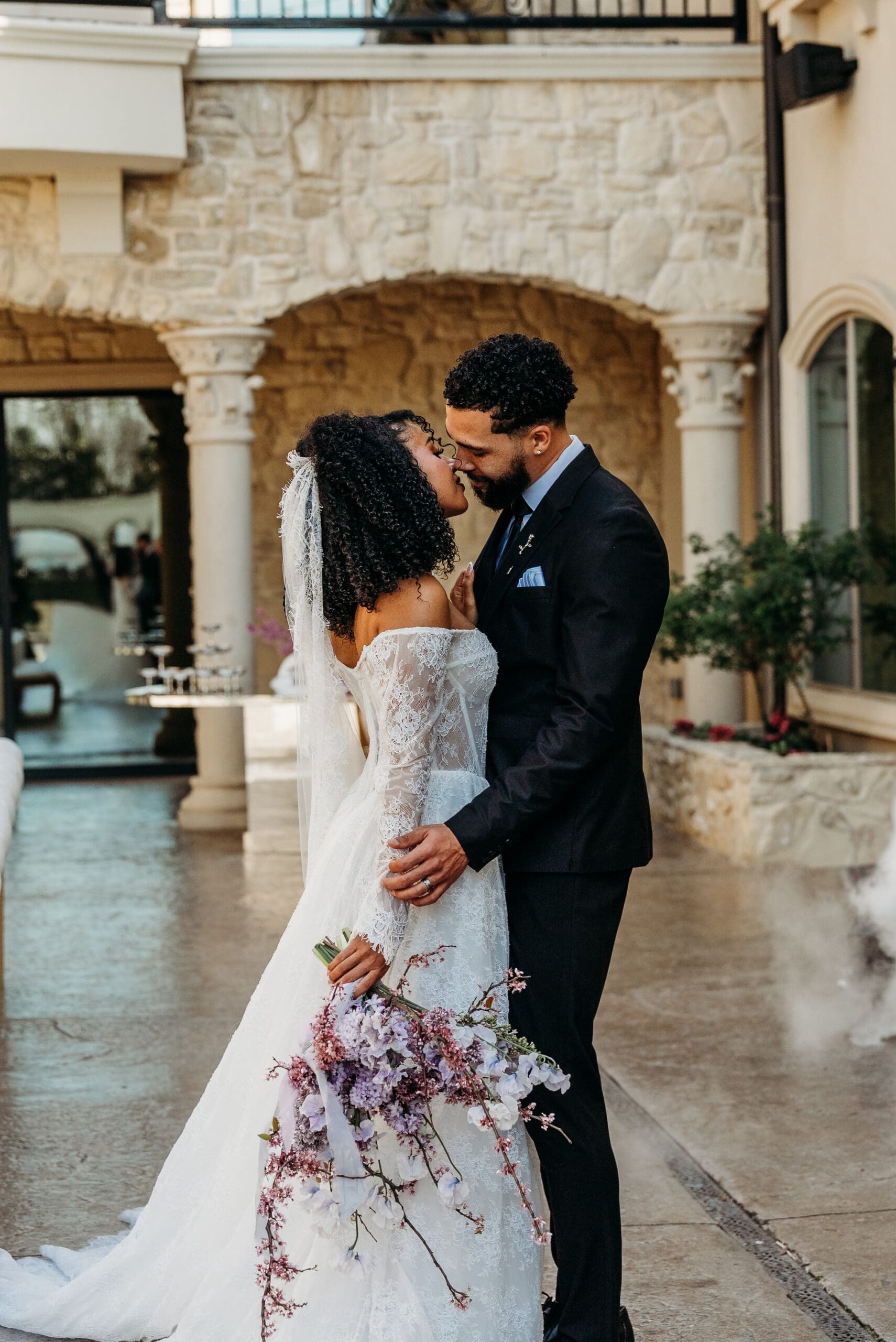 Bride and groom share an intimate moment in a rustic stone setting