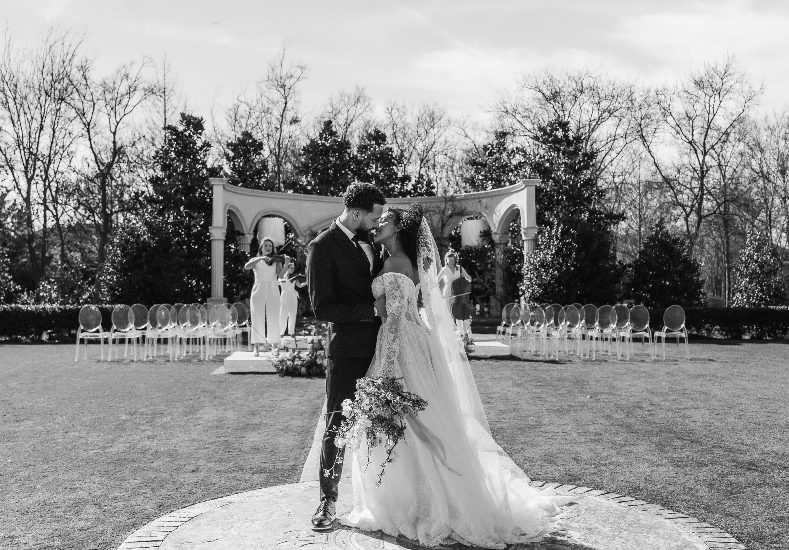 Bride and groom standing together at a formal garden ceremony