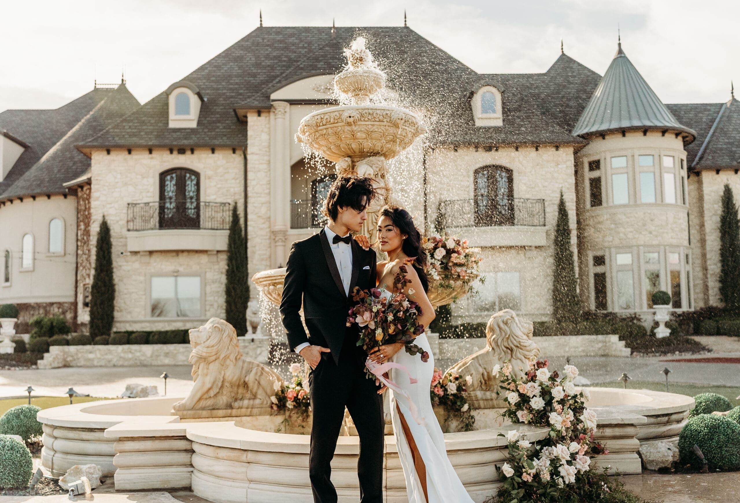 Bride and groom at an ornate floral arch during their ceremony