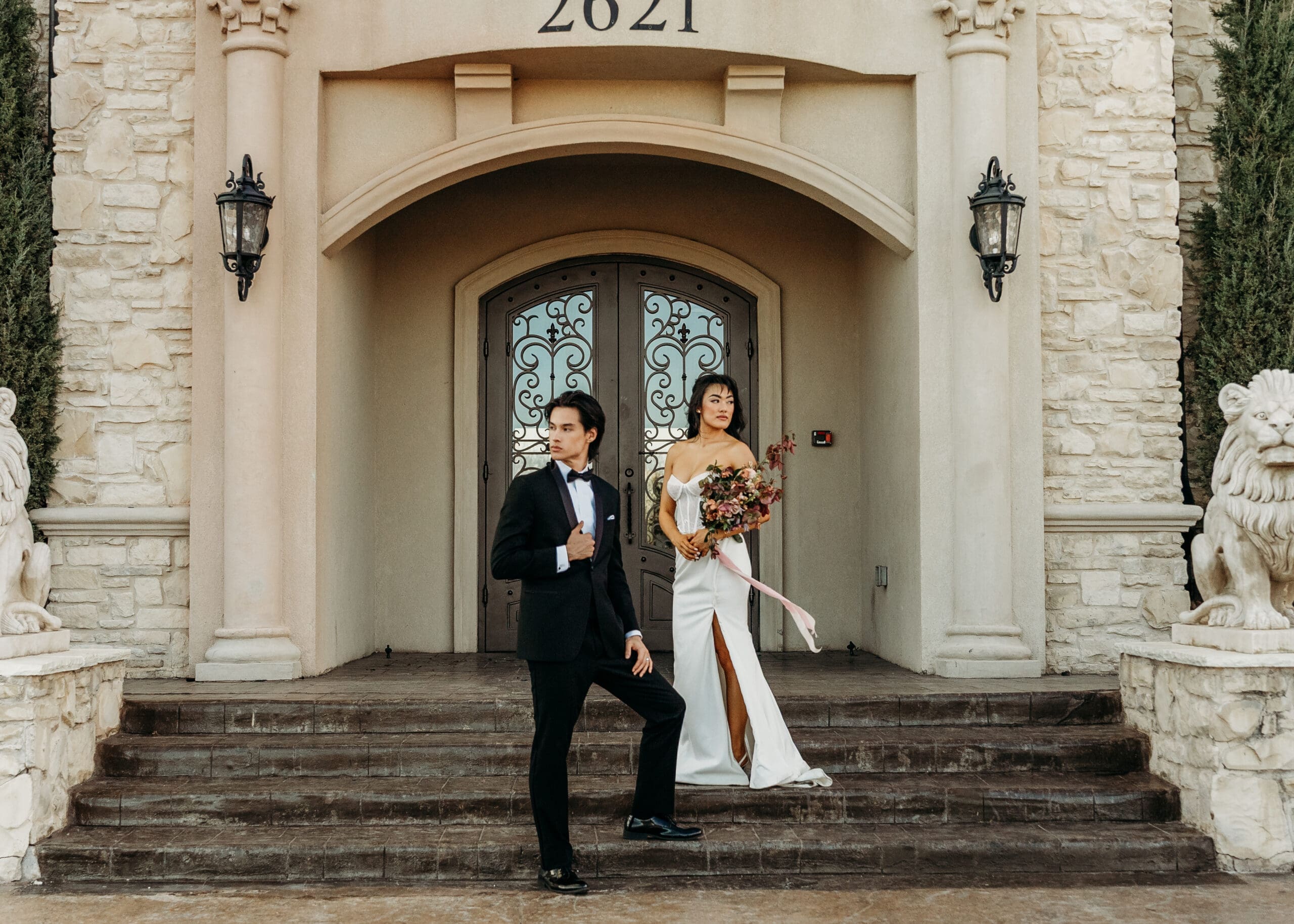 Bride and groom on the steps of an elegant historic building