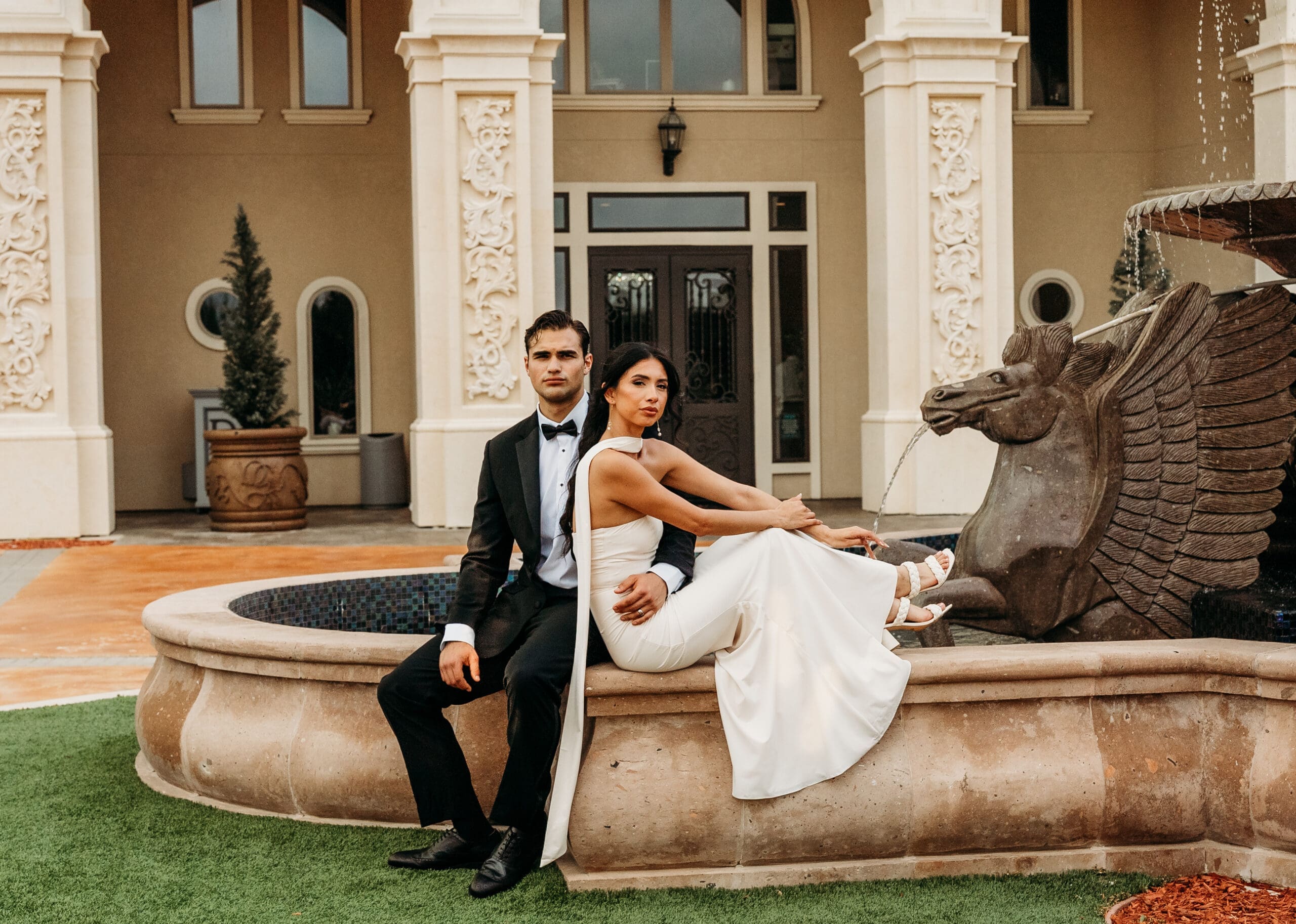 Elegantly dressed couple at a luxurious venue fountain