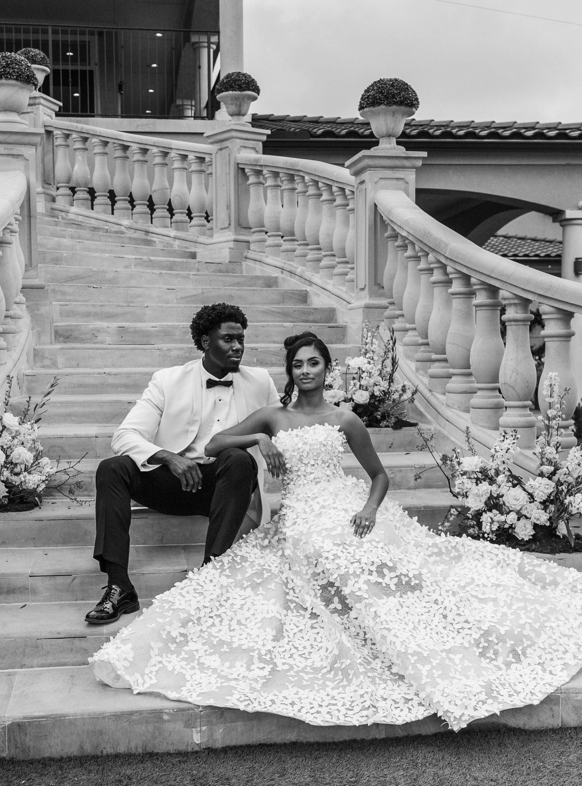 Bride and groom posing on an elegant stone staircase