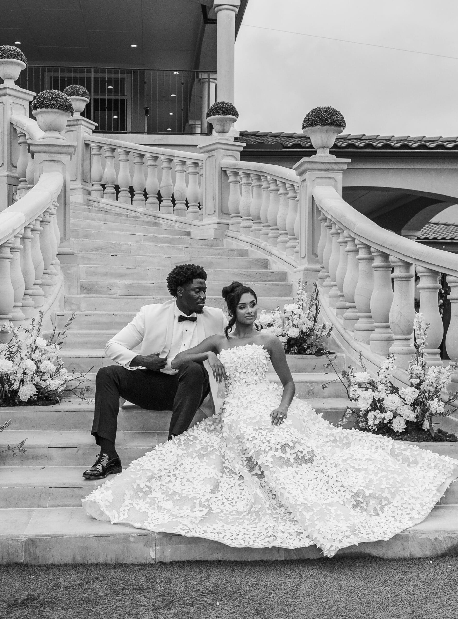 Bride and groom on an ornate balcony with decorative railing
