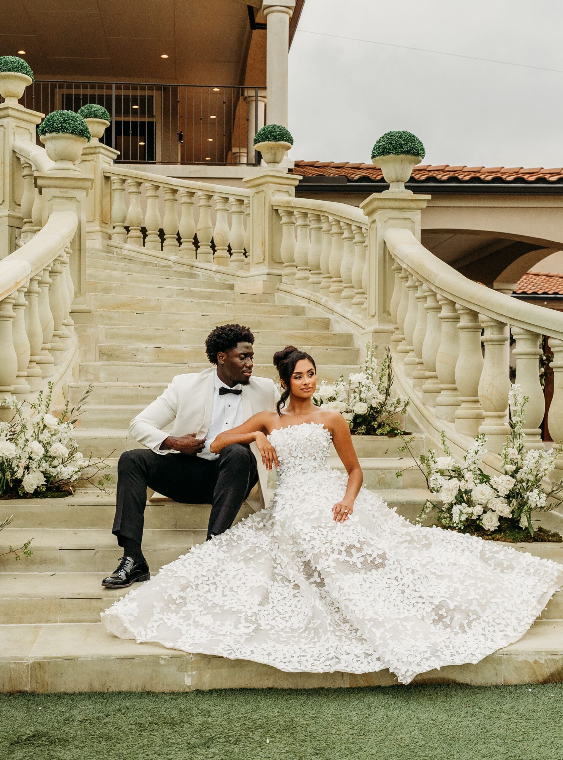 Bride and groom posing on an elegant marble staircase