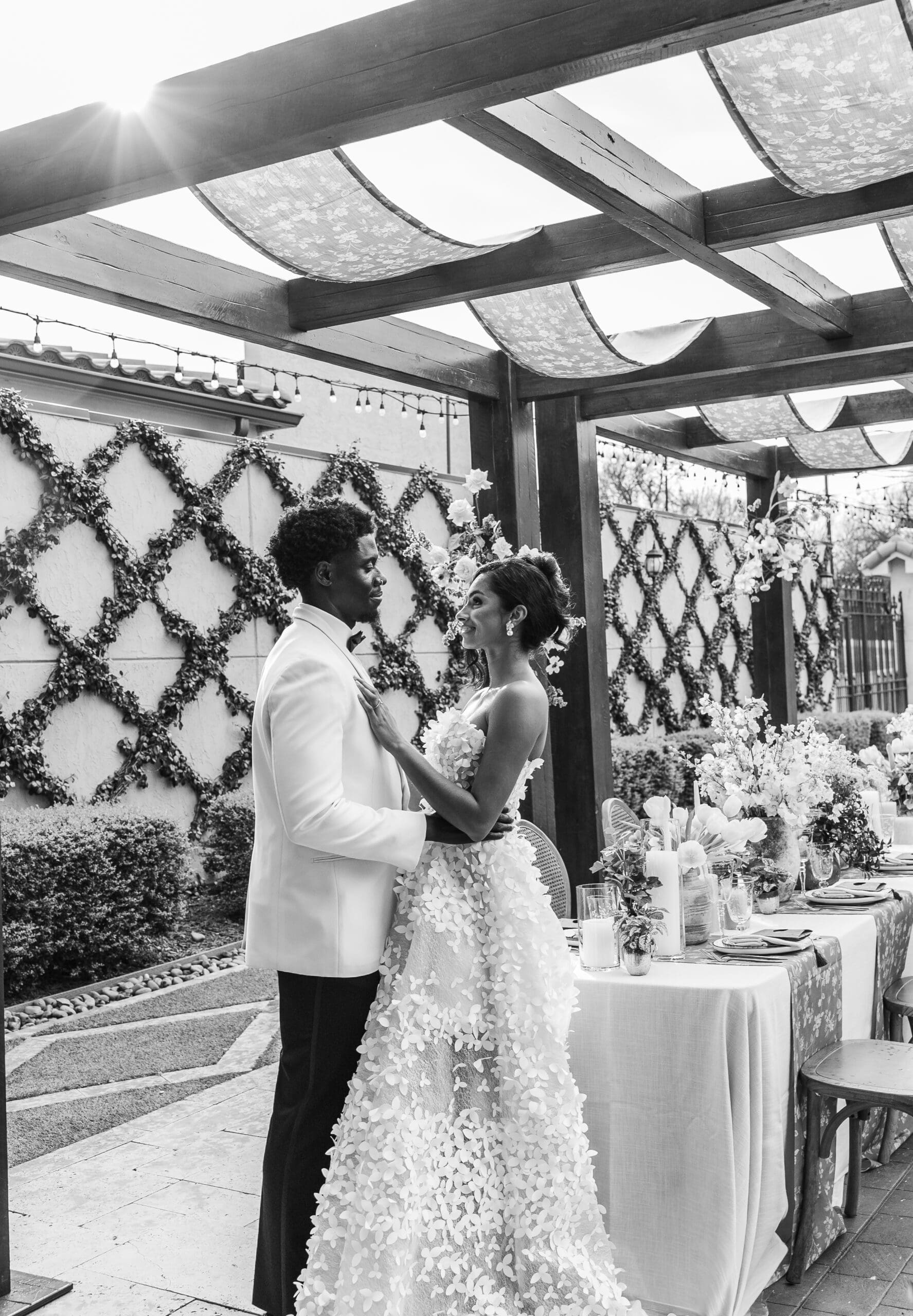 Bride and groom share an intimate moment under a pergola